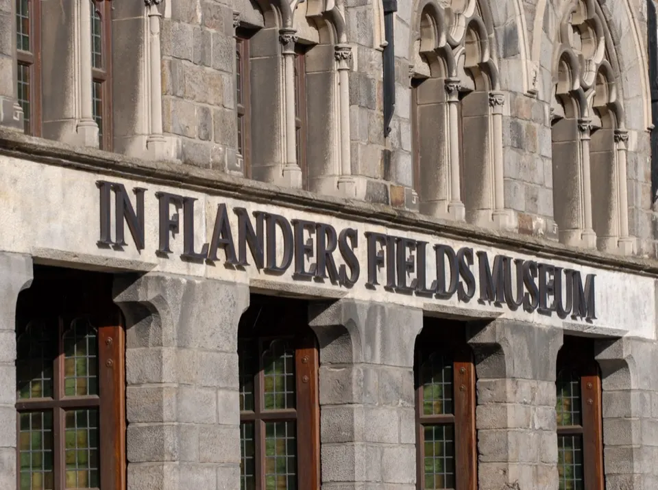 Stone facade with Gothic windows and the lettering In Flanders Fields Museum